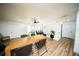 Bright dining area featuring a large wooden table, stylish chairs, and a view of the adjacent workspace and kitchen at 5365 Rambling Rd, St Cloud, FL 34771