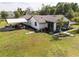 Beautifully landscaped home featuring a screened porch, carport, and lush green lawn, offering a peaceful retreat at 5365 Rambling Rd, St Cloud, FL 34771