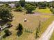 Green grass and fencing with a gated entrance in this vacant lot at 5365 Rambling Rd, St Cloud, FL 34771