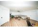 Bright living room featuring a large sectional sofa, ceiling fan, and hardwood floors, perfect for relaxation and entertainment at 5365 Rambling Rd, St Cloud, FL 34771