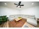 Comfortable living room with sectional seating, ceiling fan, and a cozy rug, offering a relaxing space for gatherings at 5365 Rambling Rd, St Cloud, FL 34771