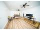 Spacious bedroom featuring sleek wood flooring, modern ceiling fans, a work-from-home desk and neutral decor at 5365 Rambling Rd, St Cloud, FL 34771