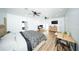 Bright and airy bedroom featuring two ceiling fans, modern work-from-home desk and sleek wood flooring at 5365 Rambling Rd, St Cloud, FL 34771