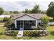 Beautiful rear exterior view featuring a screened in patio and lush landscaping at 5365 Rambling Rd, St Cloud, FL 34771