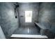 Modern shower featuring sleek tile, dark fixtures, a built-in niche, bench seat and shower window at 5365 Rambling Rd, St Cloud, FL 34771