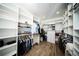 Spacious walk-in closet featuring custom shelving, hanging rods, and an abundance of storage space at 5365 Rambling Rd, St Cloud, FL 34771