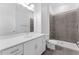 Modern bathroom featuring a white vanity, sleek fixtures, and a tiled shower with glass enclosure at 56 W Harding St, Orlando, FL 32806
