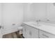 Bathroom featuring a white vanity with a large mirror, a toilet, and a towel rack, all in a modern design at 56 W Harding St, Orlando, FL 32806