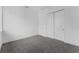 Modern bedroom with gray carpet, white walls and baseboards, with sliding door closet on the right at 56 W Harding St, Orlando, FL 32806