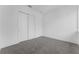 Bedroom featuring grey carpet, white walls, and a closet with large sliding doors at 56 W Harding St, Orlando, FL 32806