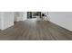 Open floor plan showcasing the dark wood laminate flooring and ample space for living and dining at 56 W Harding St, Orlando, FL 32806