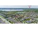 Wide aerial shot of the neighborhood with a lake and Disney's Magic Kingdom in the background at 5911 Grassy Point Rd, Winter Garden, FL 34787
