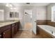 Primary bathroom featuring double vanity, soaking tub, and bedroom entrance at 5911 Grassy Point Rd, Winter Garden, FL 34787