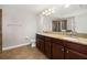 Bright bathroom with double vanity, tile flooring, and glass-enclosed shower at 5911 Grassy Point Rd, Winter Garden, FL 34787