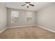 Carpeted bedroom with two windows and neutral paint at 5911 Grassy Point Rd, Winter Garden, FL 34787