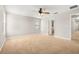 Carpeted bedroom with ceiling fan and ensuite bathroom entrance at 5911 Grassy Point Rd, Winter Garden, FL 34787