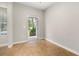 Bright, neutral room with tile floors, an open doorway, and a window providing natural light, waiting for personalization at 5911 Grassy Point Rd, Winter Garden, FL 34787