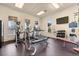 Bright fitness center with treadmills, elliptical machines, free weights, and flat screen TV at 5911 Grassy Point Rd, Winter Garden, FL 34787