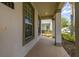 Inviting covered front porch with brick pavers and support columns, perfect for relaxing and enjoying the neighborhood at 5911 Grassy Point Rd, Winter Garden, FL 34787
