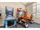 Fun game room with a pinball machine and racing game, offering entertainment and leisure activities at 5911 Grassy Point Rd, Winter Garden, FL 34787