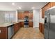 Spacious kitchen with stainless steel appliances, granite countertops, ample cabinet space, and tile flooring throughout at 5911 Grassy Point Rd, Winter Garden, FL 34787