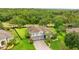 Aerial view of a meticulously landscaped home, showcasing its lush surroundings and manicured grounds at 6234 Tremayne Dr, Mount Dora, FL 32757
