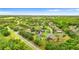 A high aerial view shows the home nestled among mature trees in an established neighborhood at 6234 Tremayne Dr, Mount Dora, FL 32757