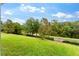 View of the backyard surrounded by a fence with trees at 6234 Tremayne Dr, Mount Dora, FL 32757