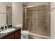 Bathroom features tile flooring, tile shower, sink, and a vanity with dark countertop at 6234 Tremayne Dr, Mount Dora, FL 32757