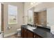 A bathroom with a large mirror, single vanity, a tiled shower, and a window at 6234 Tremayne Dr, Mount Dora, FL 32757