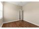 This bedroom features neutral walls, hardwood floors, and a window at 6234 Tremayne Dr, Mount Dora, FL 32757