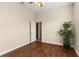 A bedroom with wood flooring, a ceiling fan, and a closet door leading to storage space at 6234 Tremayne Dr, Mount Dora, FL 32757