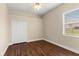 Bright bedroom features a ceiling fan, closet, window and hardwood flooring at 6234 Tremayne Dr, Mount Dora, FL 32757