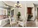 Bright dining room with a glass table set, modern chandelier, and views of the outdoor patio at 6234 Tremayne Dr, Mount Dora, FL 32757