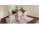 Inviting dining area featuring a decorative table setting, hardwood flooring, and ample natural light at 6234 Tremayne Dr, Mount Dora, FL 32757