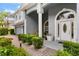 Inviting front porch with lush greenery and manicured landscaping, enhancing the home's curb appeal at 6234 Tremayne Dr, Mount Dora, FL 32757