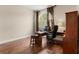The home office has hardwood floors, a large window with shutters, and a wood desk at 6234 Tremayne Dr, Mount Dora, FL 32757