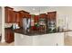 A well-equipped kitchen features dark wood cabinetry, stainless steel appliances, and granite countertops at 6234 Tremayne Dr, Mount Dora, FL 32757