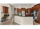 Modern kitchen with dark wood cabinetry, granite countertops, and stainless steel appliances, combining style and functionality at 6234 Tremayne Dr, Mount Dora, FL 32757