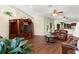 Spacious living room with hardwood floors, a leather sofa set, and ample natural light, blending comfort and style at 6234 Tremayne Dr, Mount Dora, FL 32757