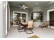 Covered back patio featuring a ceiling fan, seating, and natural light at 6234 Tremayne Dr, Mount Dora, FL 32757