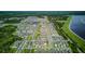 Wide aerial view of community homes near a scenic lake at 625 Dogfish Ln, Debary, FL 32713