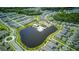 Aerial view of a community featuring a pool and central lake at 625 Dogfish Ln, Debary, FL 32713