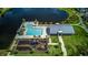 Overhead community view featuring a pool, clubhouse, and playground near a serene lake, ideal for leisure activities at 625 Dogfish Ln, Debary, FL 32713