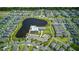 This aerial view shows a lakefront community surrounded by lush green landscaping and meticulously-maintained homes at 625 Dogfish Ln, Debary, FL 32713