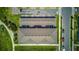 Aerial view showcasing rooftops of townhomes, along with paved parking and green space at 625 Dogfish Ln, Debary, FL 32713