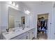 A well-lit bathroom features a double vanity and a walk-in closet at 625 Dogfish Ln, Debary, FL 32713