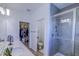 A bright bathroom features a double vanity, a walk-in closet, and a walk-in shower at 625 Dogfish Ln, Debary, FL 32713