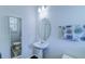 Charming bathroom features a pedestal sink, oval mirror, and decorative floral accents at 625 Dogfish Ln, Debary, FL 32713