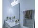 Bright bathroom showcasing a large mirror, modern vanity with quartz counters, and fresh plants for decor at 625 Dogfish Ln, Debary, FL 32713